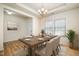 Elegant dining room featuring a large table, chandelier, and natural light from the window at 1008 Scotch Pine Way, Mebane, NC 27302