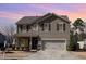 A lovely two-story home with a two-car garage and tidy landscaping is highlighted against a colorful sunset at 1008 Scotch Pine Way, Mebane, NC 27302
