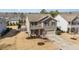 Charming two-story home featuring a well-maintained lawn, covered porch, and attached two-car garage at 1008 Scotch Pine Way, Mebane, NC 27302