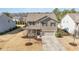 Charming two-story home featuring a well-maintained lawn, covered porch, and attached two-car garage at 1008 Scotch Pine Way, Mebane, NC 27302