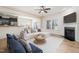 Bright living room with a fireplace, ceiling fan, and an open concept view to the dining area at 1008 Scotch Pine Way, Mebane, NC 27302