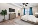 This main bedroom features neutral decor, TV, ceiling fan, and ensuite access at 1008 Scotch Pine Way, Mebane, NC 27302