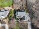 Aerial view of a large estate featuring a custom home, mature trees, and landscaping at 102 Shepton Dr, Cary, NC 27519
