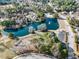 Aerial view of a neighborhood featuring a playground, lake, and recreational facilities at 102 Shepton Dr, Cary, NC 27519