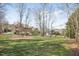 Sprawling backyard with mature trees and lush greenery, offering ample space and privacy behind the home at 102 Shepton Dr, Cary, NC 27519