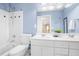 Light and bright bathroom featuring double sinks, and a shower-tub combination at 102 Shepton Dr, Cary, NC 27519