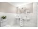 Bright bathroom featuring dual vessel sinks, white tile, and modern fixtures at 102 Shepton Dr, Cary, NC 27519