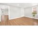 Bedroom with built-in shelves, window view, and hardwood floors at 102 Shepton Dr, Cary, NC 27519
