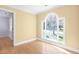 Sunlit bedroom featuring warm yellow walls, hardwood floors, and a large window at 102 Shepton Dr, Cary, NC 27519