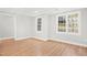 Versatile bonus room with hardwood floors, recessed lighting, and natural light from large windows at 102 Shepton Dr, Cary, NC 27519