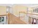 Hallway with luxury vinyl plank floors, chandelier, and staircase to lower level at 102 Shepton Dr, Cary, NC 27519