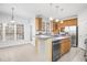 Bright kitchen with stainless steel appliances, island with bar seating, and tile flooring at 102 Shepton Dr, Cary, NC 27519