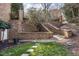 Tiered brick landscaping with stairs leading to a backyard, showcasing meticulous design and greenery at 102 Shepton Dr, Cary, NC 27519