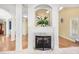 Elegant living room with marble fireplace, decorative screen, and open staircase at 102 Shepton Dr, Cary, NC 27519