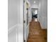 Bright hallway with wood floors and white trim leading to other rooms in the home at 104 Whistling Way # Brunswick English Country, Lillington, NC 27546