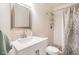 Well-lit bathroom features a shower, white vanity and modern fixtures at 105 Fidelity St # B24, Carrboro, NC 27510