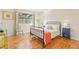 Cozy bedroom features hardwood floors, a large window, and stylish furnishings at 105 Fidelity St # B24, Carrboro, NC 27510