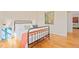 Stylish bedroom with hardwood floors, black metal bed, and unique decor at 105 Fidelity St # B24, Carrboro, NC 27510