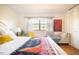 Charming bedroom features natural light, wood floors, closet, and a cozy chair at 105 Fidelity St # B24, Carrboro, NC 27510