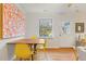 Bright dining area featuring hardwood floors, neutral paint, large picture window, and a modern art piece at 105 Fidelity St # B24, Carrboro, NC 27510