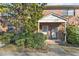 Inviting brick townhome exterior with a cozy entrance and lush greenery around the front door at 105 Fidelity St # B24, Carrboro, NC 27510