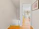 Bright hallway with hardwood floors leading to a bedroom with natural light at 105 Fidelity St # B24, Carrboro, NC 27510