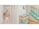 Bright hallway with artwork leading to a green staircase and an open view of the dining area at 105 Fidelity St # B24, Carrboro, NC 27510