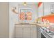 Charming kitchen features bright orange accents, stainless steel appliances, and butcher block counters at 105 Fidelity St # B24, Carrboro, NC 27510