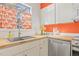 Bright kitchen with stainless steel appliances, butcher block counters and colorful orange accents at 105 Fidelity St # B24, Carrboro, NC 27510