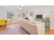Comfortable living room with hardwood floors, neutral paint, ceiling fan, large windows and eclectic decor at 105 Fidelity St # B24, Carrboro, NC 27510