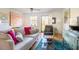 Comfortable living room with hardwood floors, neutral paint, ceiling fan, large windows and eclectic decor at 105 Fidelity St # B24, Carrboro, NC 27510