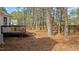 Spacious backyard with a deck, surrounded by towering trees, and lush natural beauty at 1109 Sorcerer Ct Ct, Knightdale, NC 27545