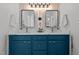 Modern bathroom with double vanity, quartz countertop, stylish mirrors, and bright lighting at 1109 Sorcerer Ct Ct, Knightdale, NC 27545