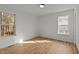 Bright, airy bedroom with wood floors and two windows providing natural light at 1109 Sorcerer Ct Ct, Knightdale, NC 27545