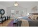 Charming bedroom with wood floors, modern lighting, large windows, and stylish decor at 1109 Sorcerer Ct Ct, Knightdale, NC 27545