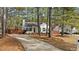 Single-Gathering home featuring a well-maintained lawn, inviting front porch framed by mature trees at 1109 Sorcerer Ct Ct, Knightdale, NC 27545