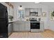 Updated kitchen featuring stainless steel appliances, grey cabinets and natural light at 1109 Sorcerer Ct Ct, Knightdale, NC 27545