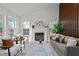 Bright living room with vaulted ceilings showcasing a fireplace, light grey sofa and chairs at 1109 Sorcerer Ct Ct, Knightdale, NC 27545