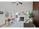 Bright living room with a fireplace, grey sofa and chairs, featuring lots of natural light at 1109 Sorcerer Ct Ct, Knightdale, NC 27545
