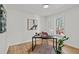 Well-lit office with modern desk, chair, round rug, wood flooring, and ample natural light at 1109 Sorcerer Ct Ct, Knightdale, NC 27545