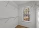 Bright walk-in closet with natural light, wire shelving, and hardwood floors at 1109 Sorcerer Ct Ct, Knightdale, NC 27545