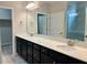 Bathroom featuring a double sink vanity with quartz countertop and a large mirror at 111 Kalmia Dr, Durham, NC 27703