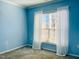 Serene bedroom with a large window and soft blue walls for a tranquil ambiance at 111 Kalmia Dr, Durham, NC 27703