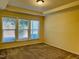 Spacious bedroom with carpet, tray ceilings, and multiple windows offering plenty of natural light at 111 Kalmia Dr, Durham, NC 27703