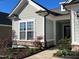 Inviting front exterior featuring stone accents, manicured landscaping, and a well-lit entryway at 111 Kalmia Dr, Durham, NC 27703