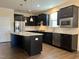Modern kitchen with dark cabinets, stainless steel appliances, and island at 111 Kalmia Dr, Durham, NC 27703