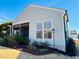 Lovely rear exterior showcasing a screened-in porch, well-maintained siding and blooming landscape beds at 111 Kalmia Dr, Durham, NC 27703