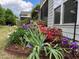 Beautiful landscaping, including colorful iris and azaleas, enhance the curb appeal of this home's exterior at 111 Kalmia Dr, Durham, NC 27703