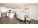 A well-lit dining room with modern decor, stainless appliances, and hard surface flooring at 114 Johnson Ridge Way, Four Oaks, NC 27524