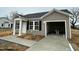 Attractive single-story home with vinyl siding, black shutters, and a concrete driveway to attached garage at 114 Johnson Ridge Way, Four Oaks, NC 27524